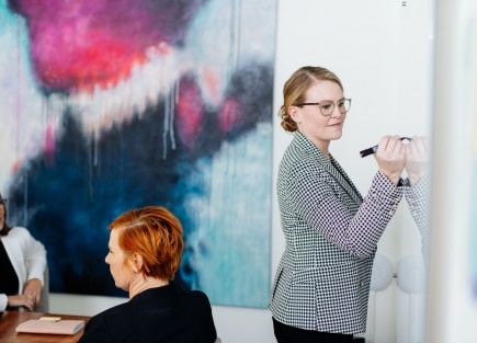 PerformHR employee writing on a whiteboard